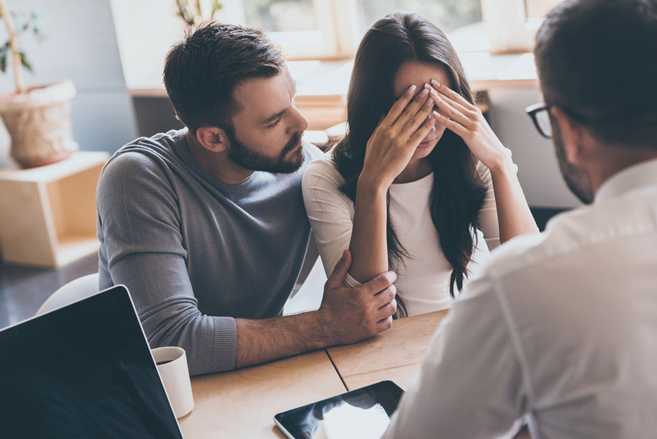 Man comforting his wife about biochemical pregnancy