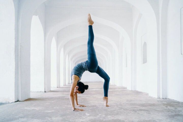 Woman doing one of the most difficult yoga poses that help boost fertility