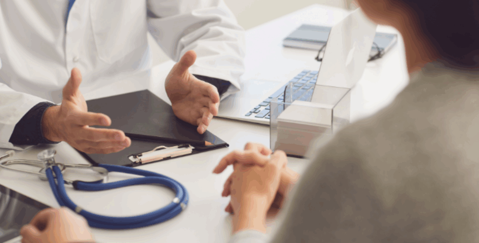 A couple talking with their doctor to see if an abortion affected their fertility.