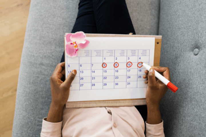 A woman marking off the days on a calendar after an embryo transfer.